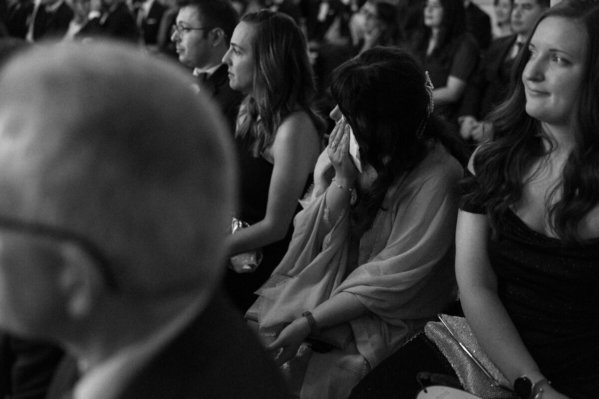 Guest wiping tears away during heartfelt vows at ceremony in Biltmore Estate Asheville NC, by Andrea-Marie Photography