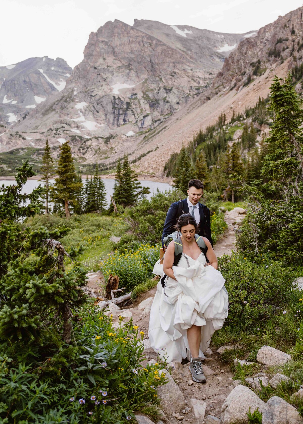 Couple hikes together to Lake Isabelle, Colorado for their sunrise elopement ceremony.