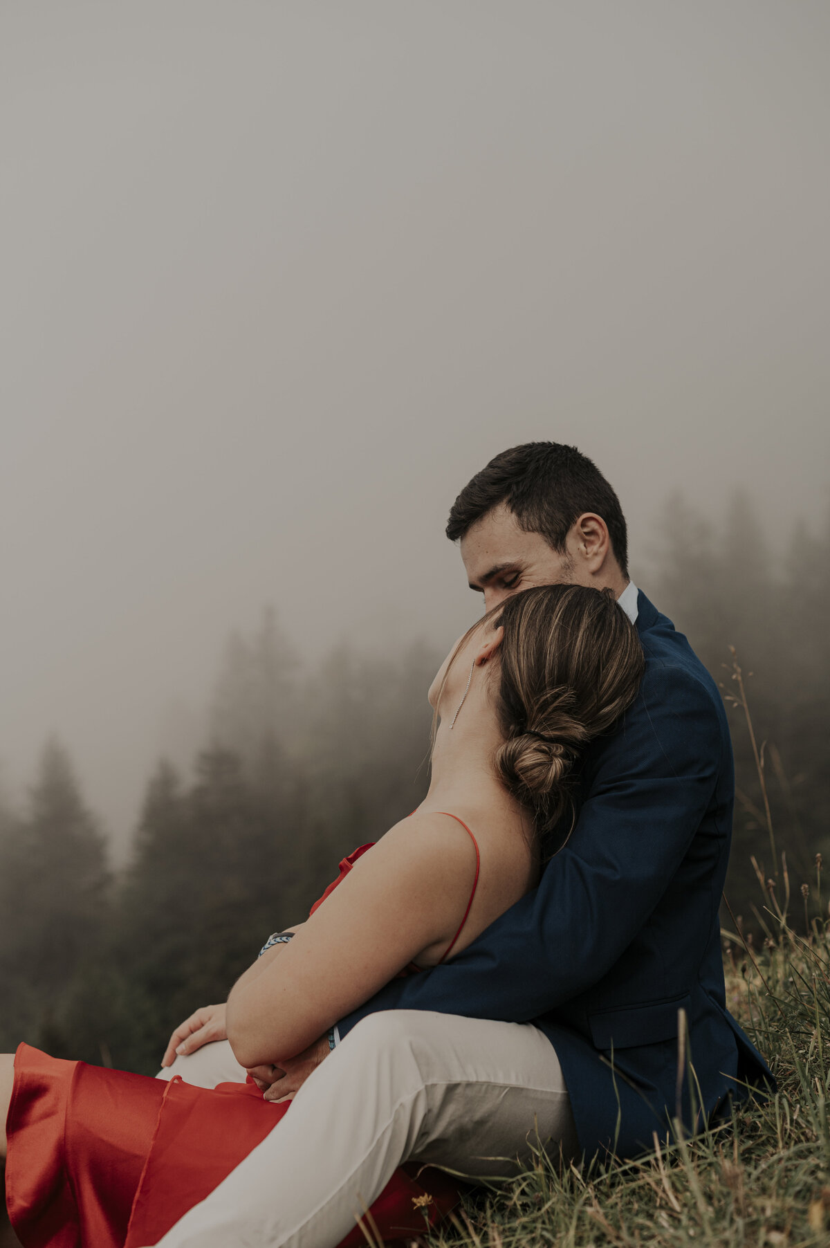Couple kissing in a forest in the French Alps