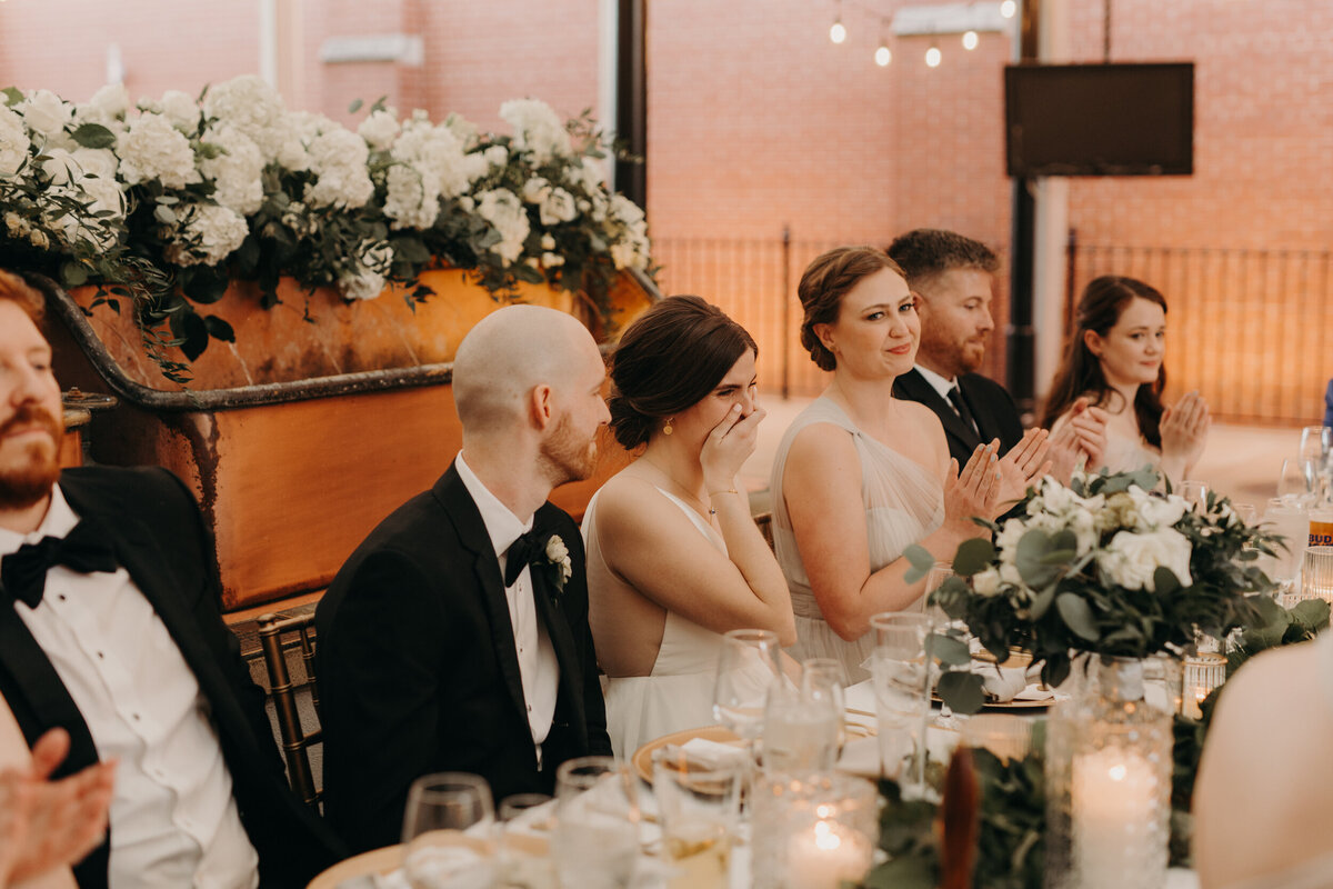 Emotional bride during toasts at Anheuser-Busch Biergarten