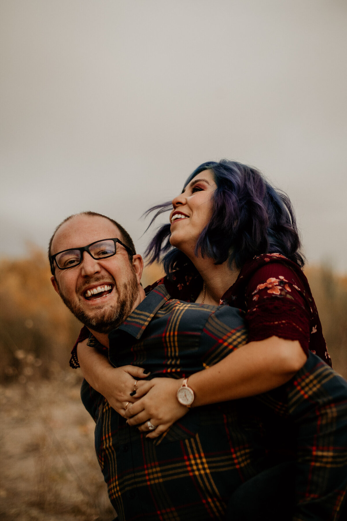husband holding wife while laughing