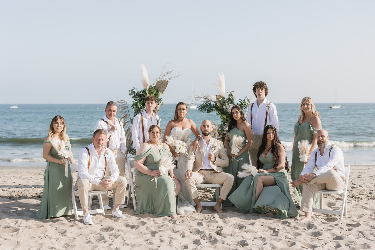 Bride and groom posing with bridal party for a portrait at Hilton Beachfront Resort Santa Barbara