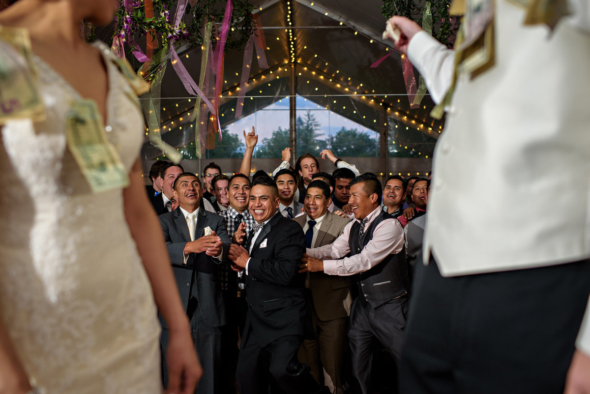 Single men line up to catch the garter during a mexican wedding  at Pearl S Buck Estate.