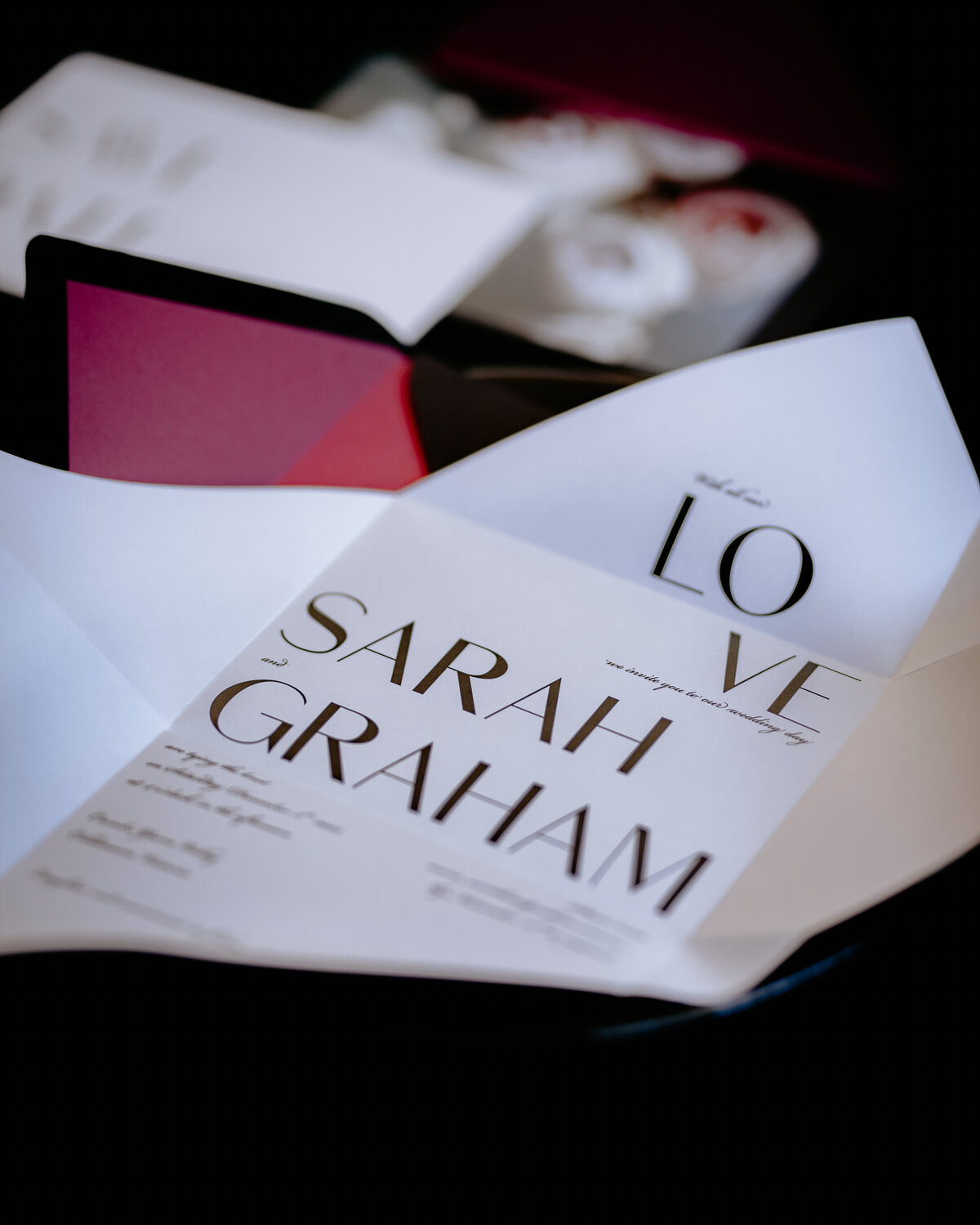 Bold black origami folded wedding invitation with black and plum envelope