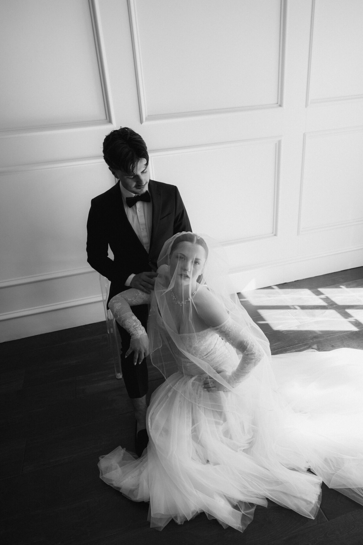 Classic Black and White Wedding Portrait with Bride on Floor