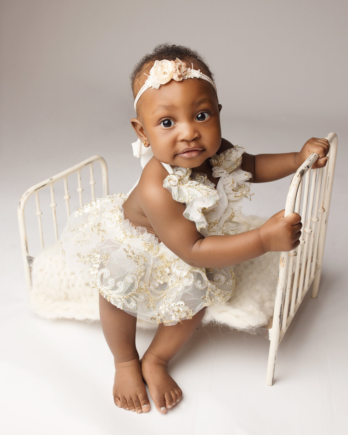 baby girl in white and gold dress in edmonton studio