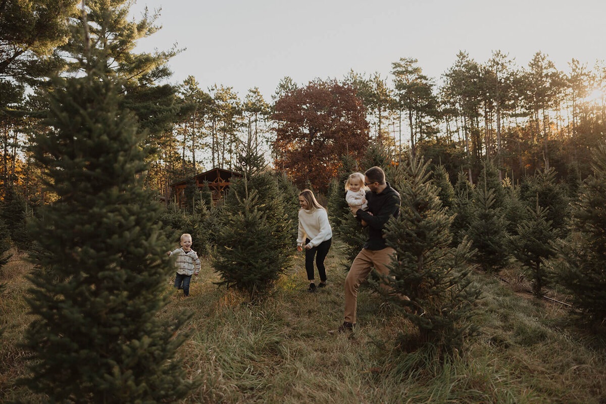 Young family romps among the pine trees in Minnesota