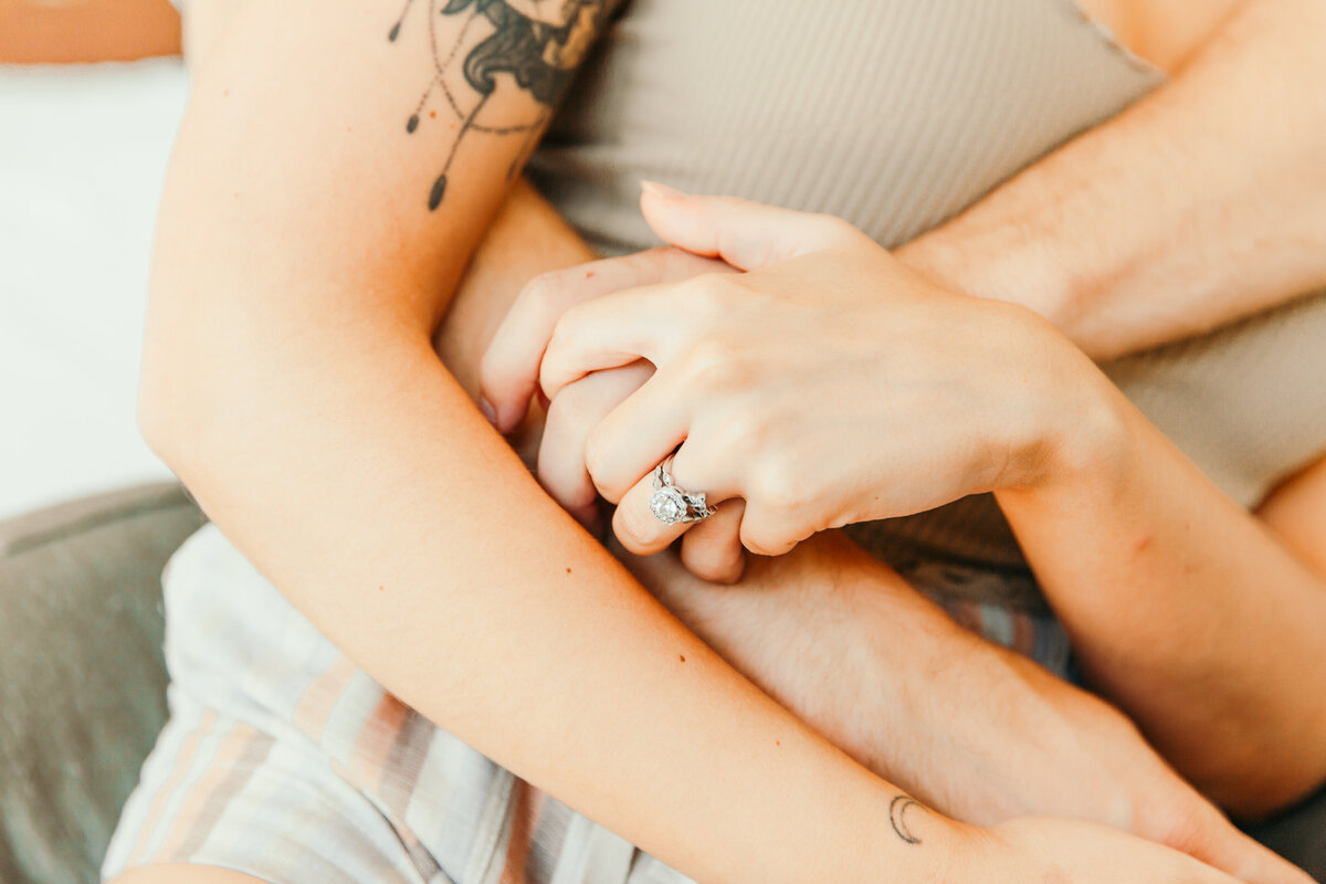 close up of hands being held in bed