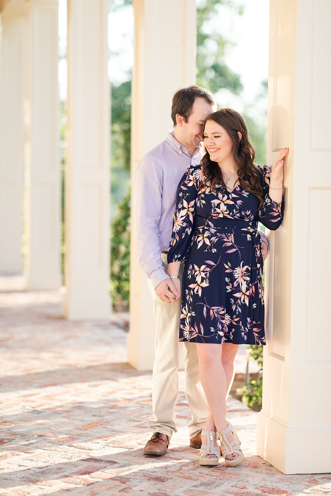 Engagement photo of couple on porch with columns