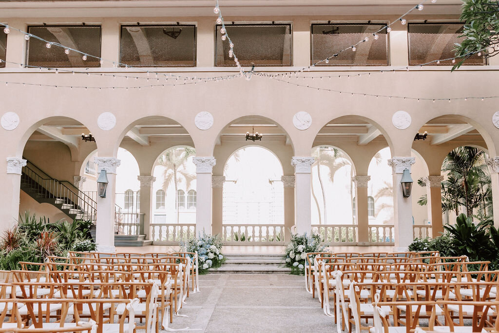 ceremony at cafe julia with arches and wishbone chairs