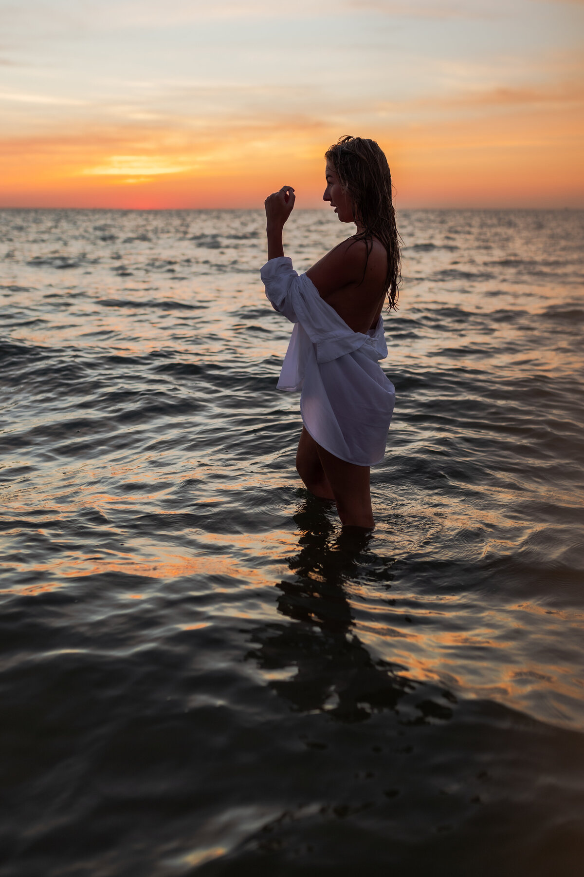 Gentle play of light and shadow on a woman's body during golden hour.