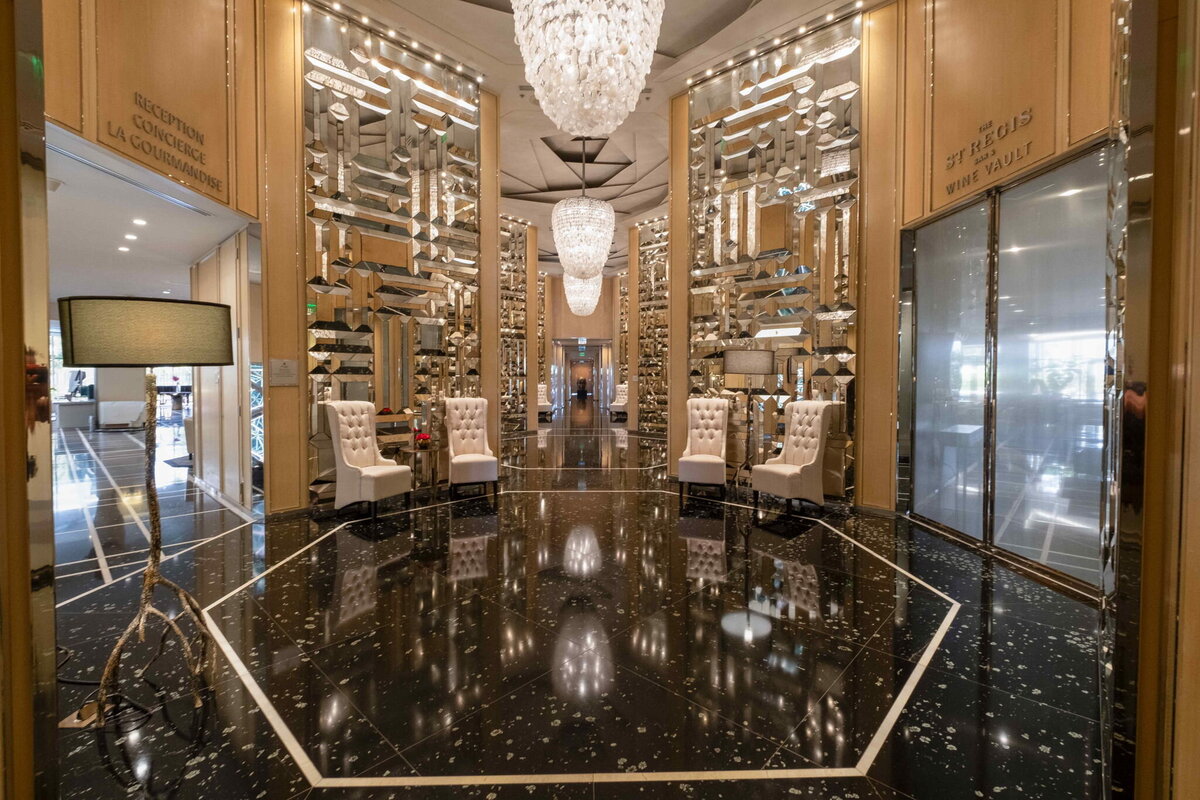  Elegant marble lobby with designer lighting at St. Regis Bal Harbour, offering private elevator access to PH-888 penthouse
