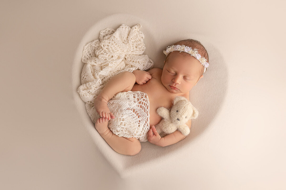 cute baby in heart bowl