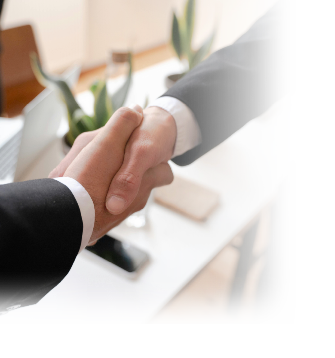 A Federated consultant shaking hands with a client who trusts us to provide advisory services that help them successfully buy or sell their funeral home.