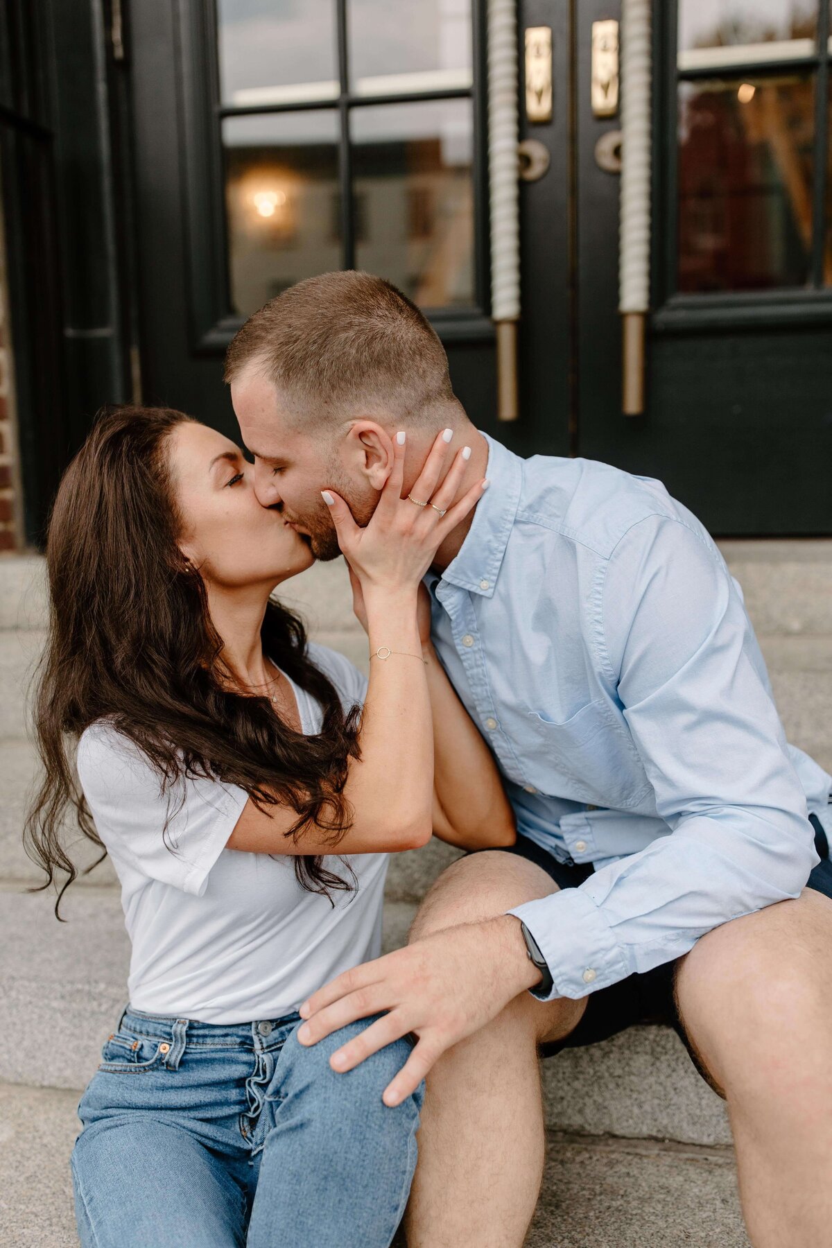 couple kissing and sitting on steps baltimore maryland city engagement session sabrina leigh photography