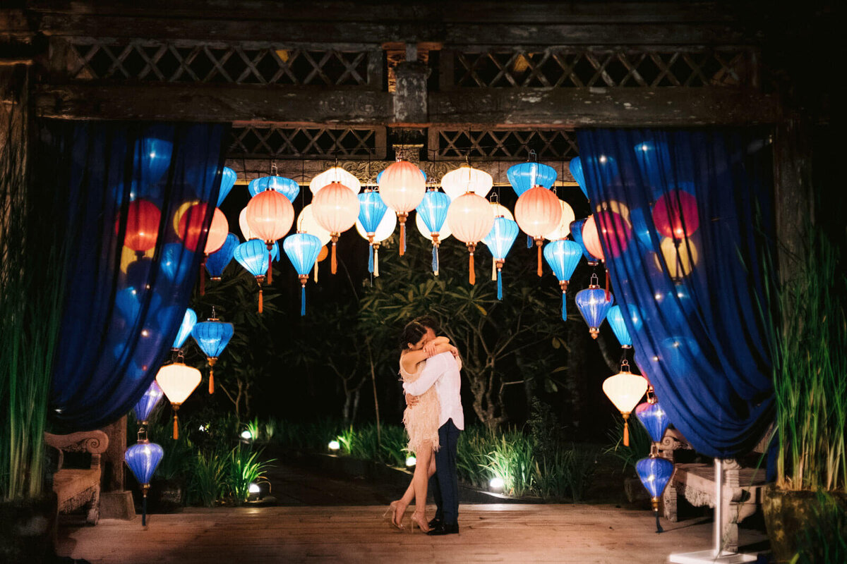 The bride and groom are hugging each other tightly in the colorful centerstage in Khayangan Estate, Bali, Indonesia. Image by Jenny Fu Studio