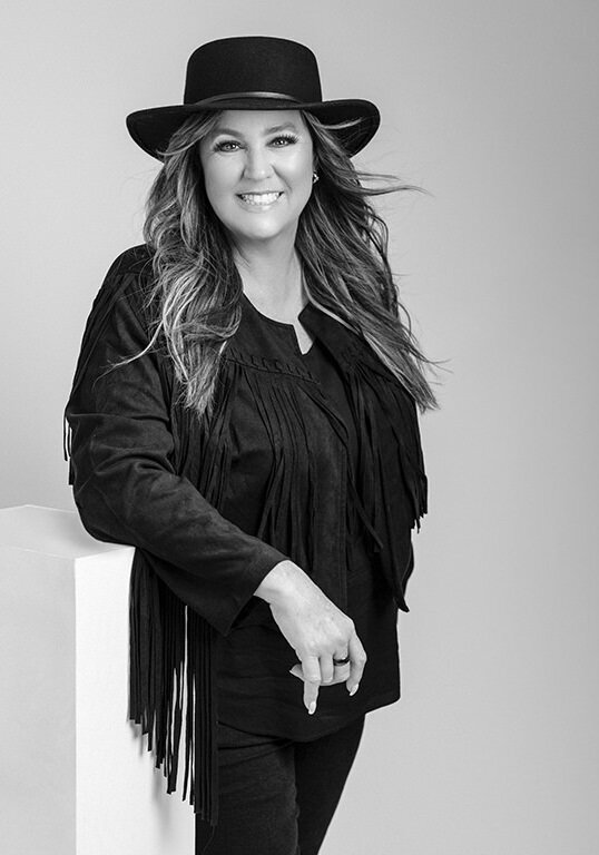 Empowered and sophisticated portrait of a woman with flawless styling and a confident gaze.