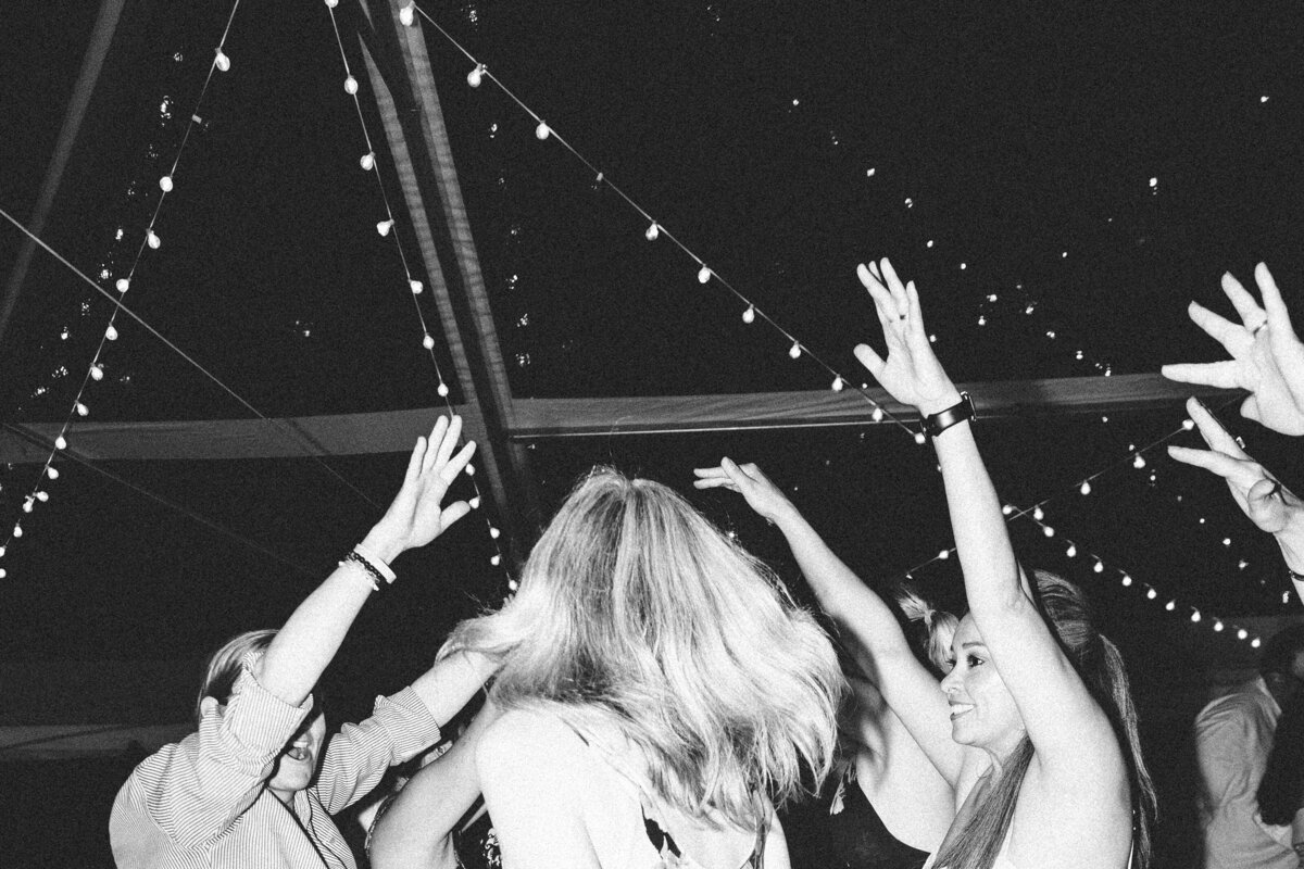 Black and white photo of guests dancing in private backyard party by Mira Park Photography NY based wedding photographer
