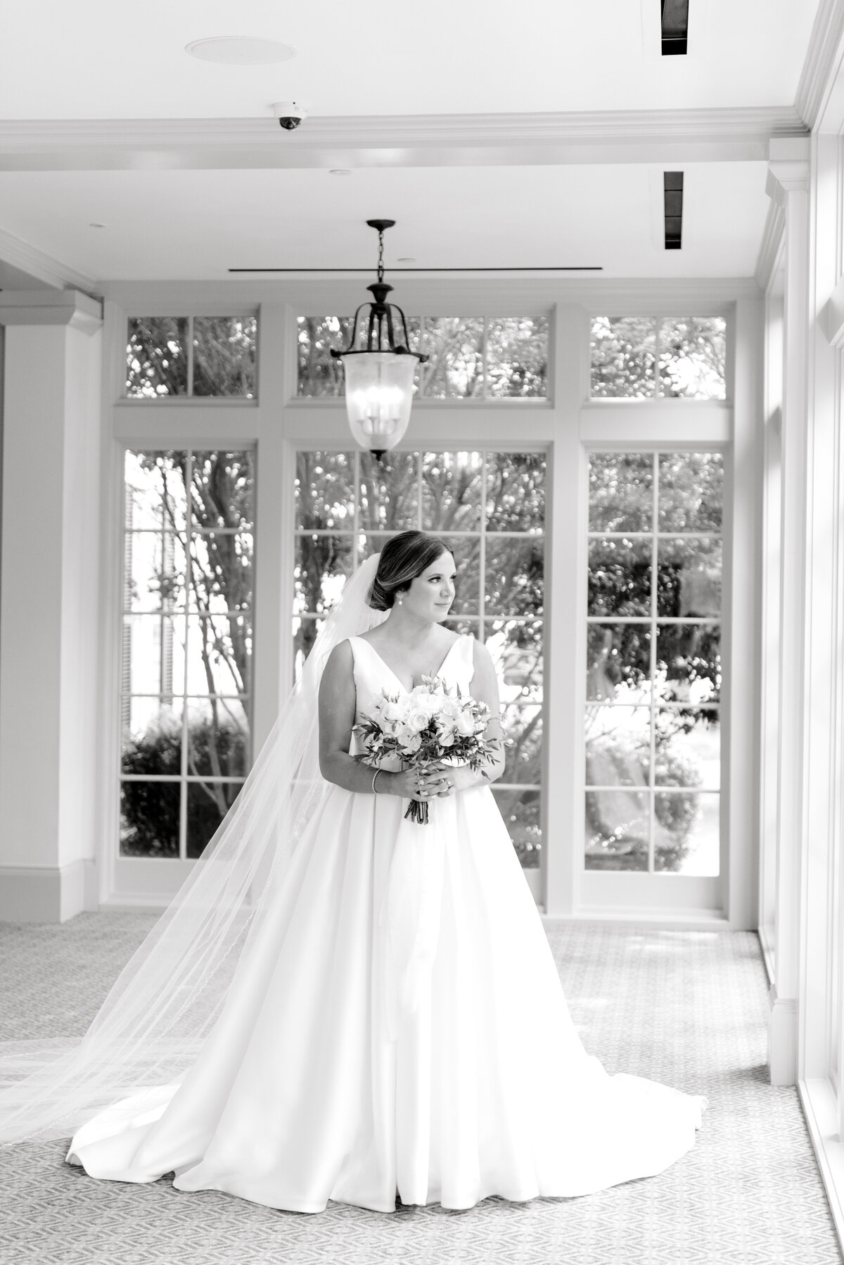 bride posing by window