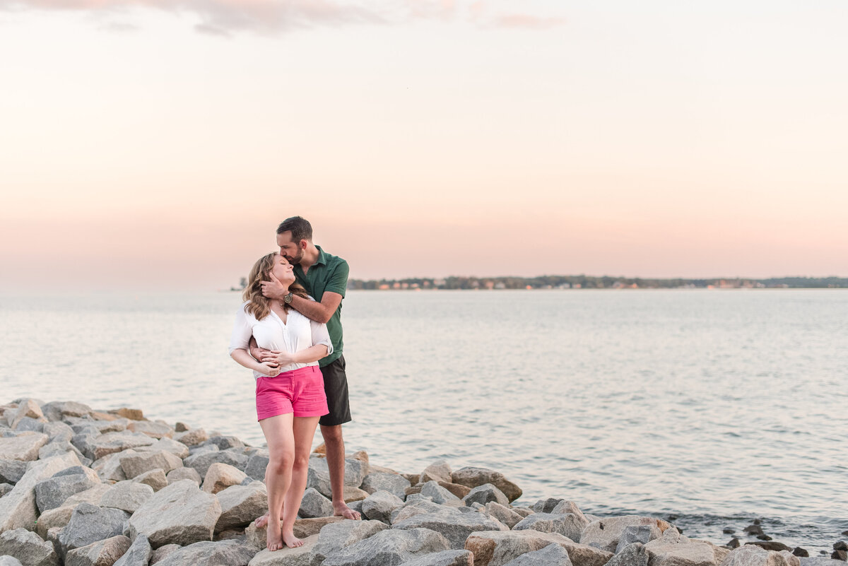 couple embracing romantically on  beach at sunset