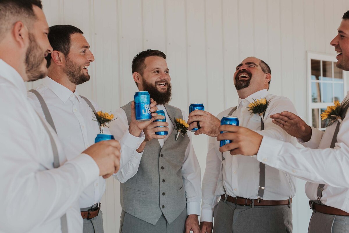 groom-groomsmen-share-beer-laughing