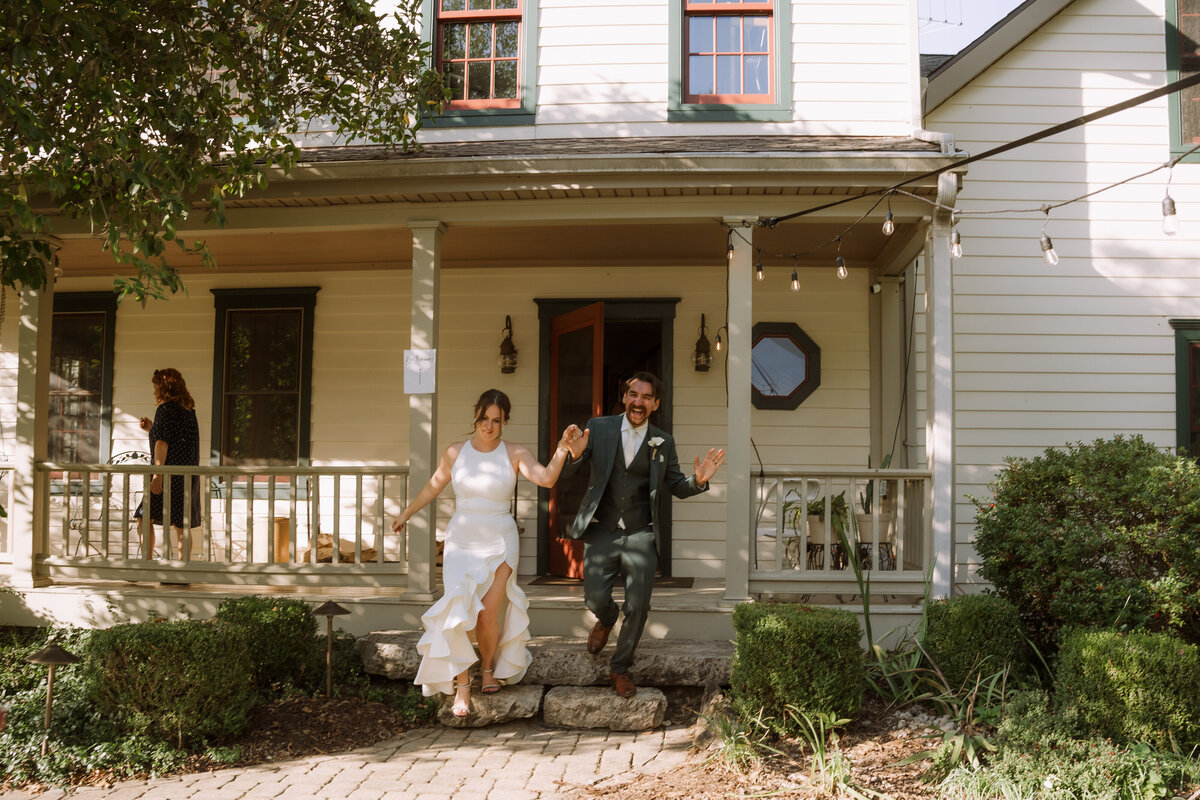 bride and groom running out of house happily, destination wedding