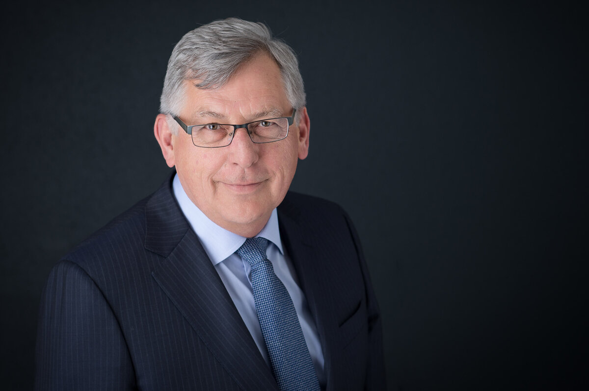 Ottawa headshot photography showing a male lawyer in a blue suit on a black backdrop taken by JEMMAN Photography Commercial