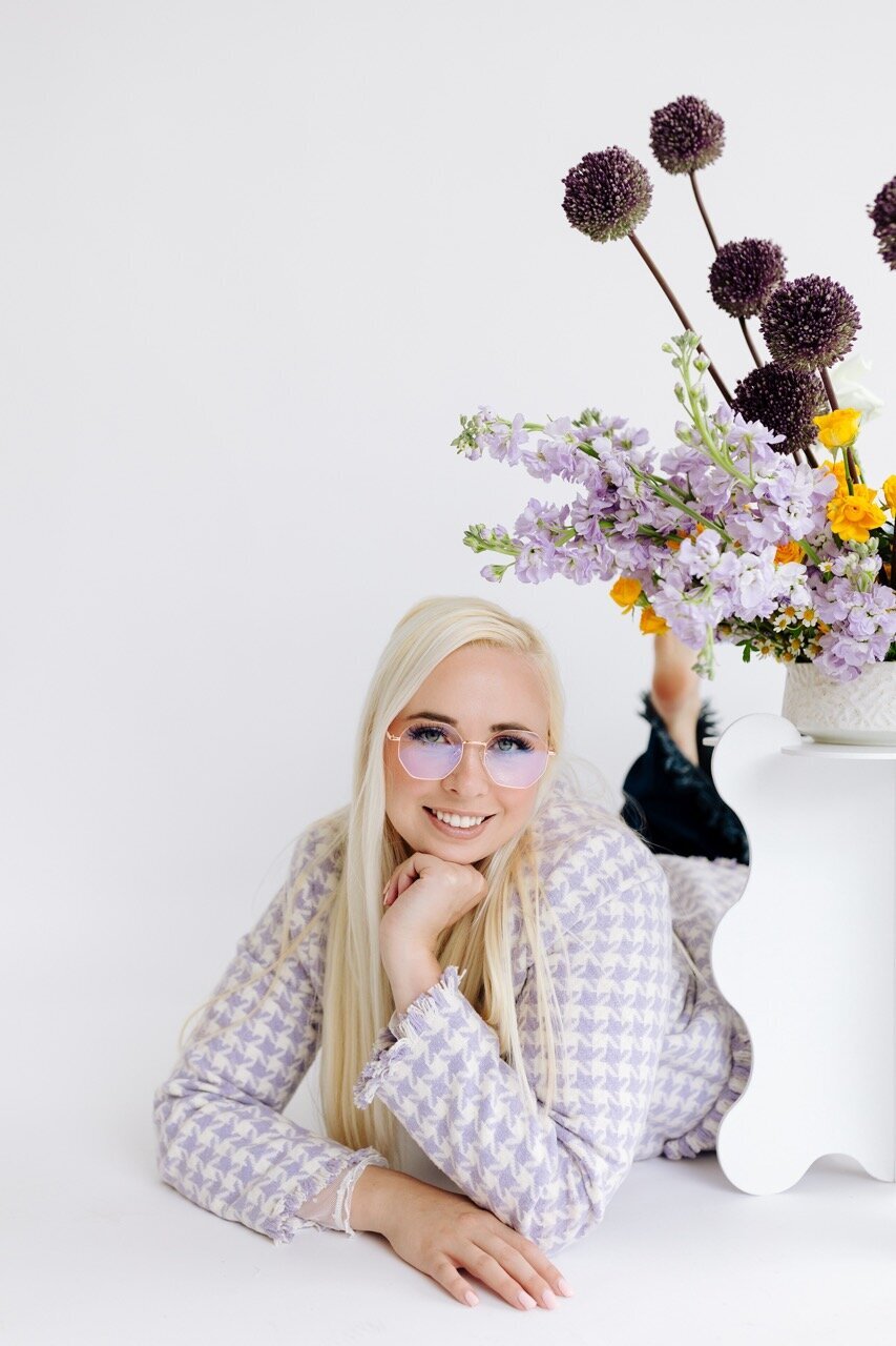 Designer in white studio with flowers
