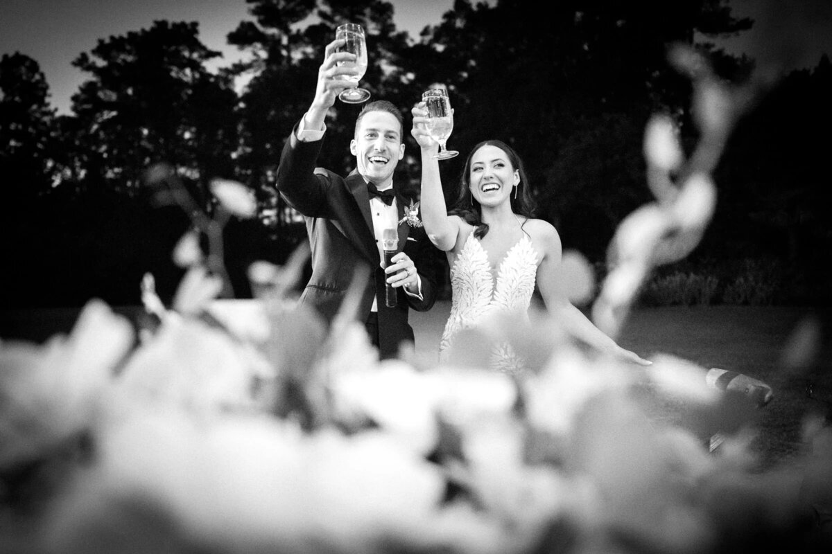 Bride and groom cheerfully toast with champagne