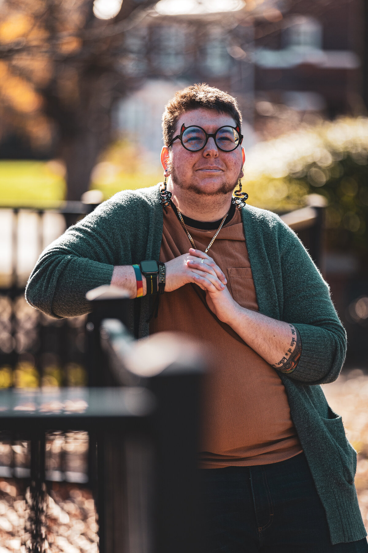 A person leaning on a fence