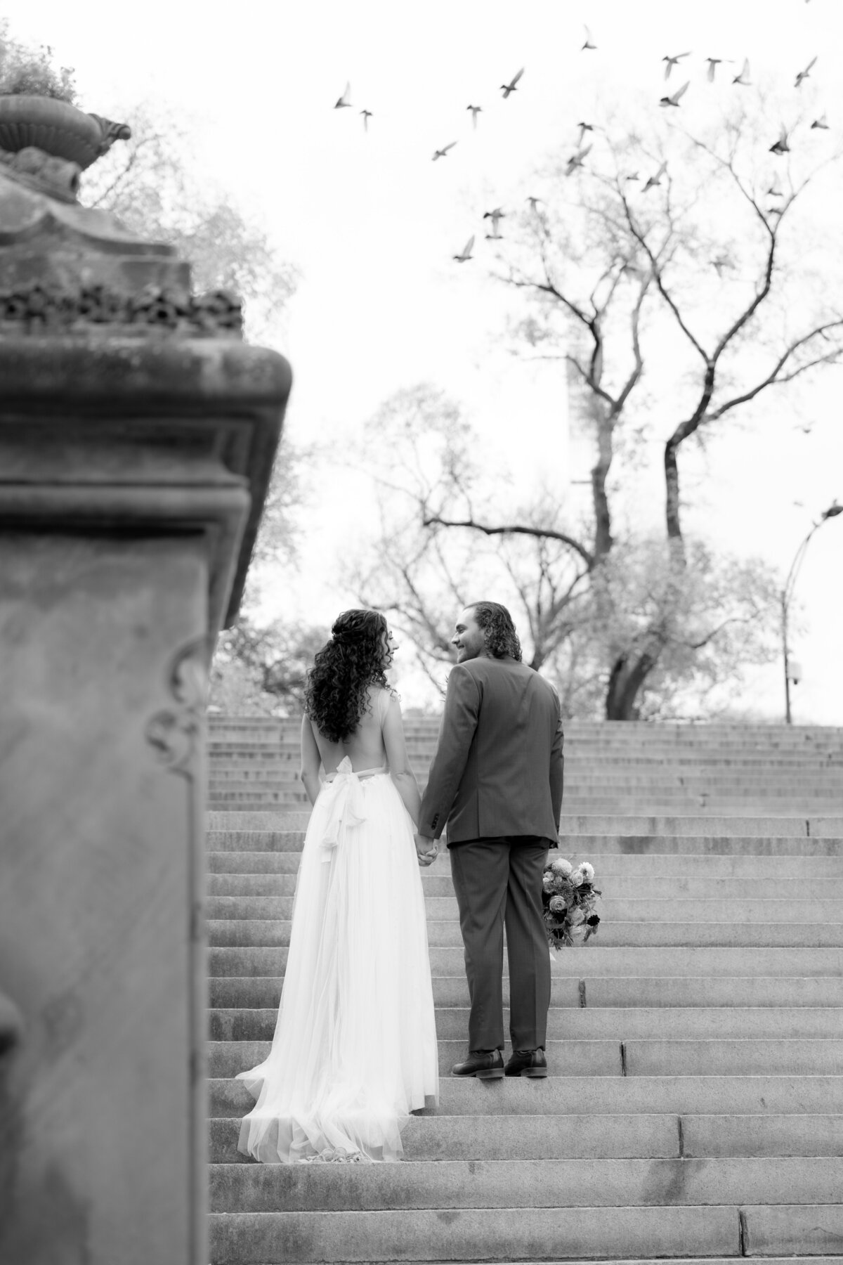 Bride and groom sharing a quiet moment under golden fall trees in Central Park.
