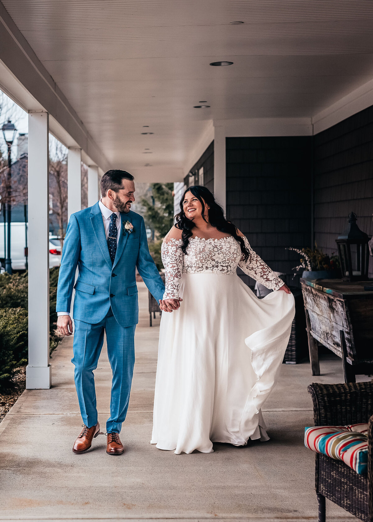 Bride and groom holding hands and looking into each others eyes while walking at Bedford Village Inn wedding in Bedford NH by Lisa Smith Photography