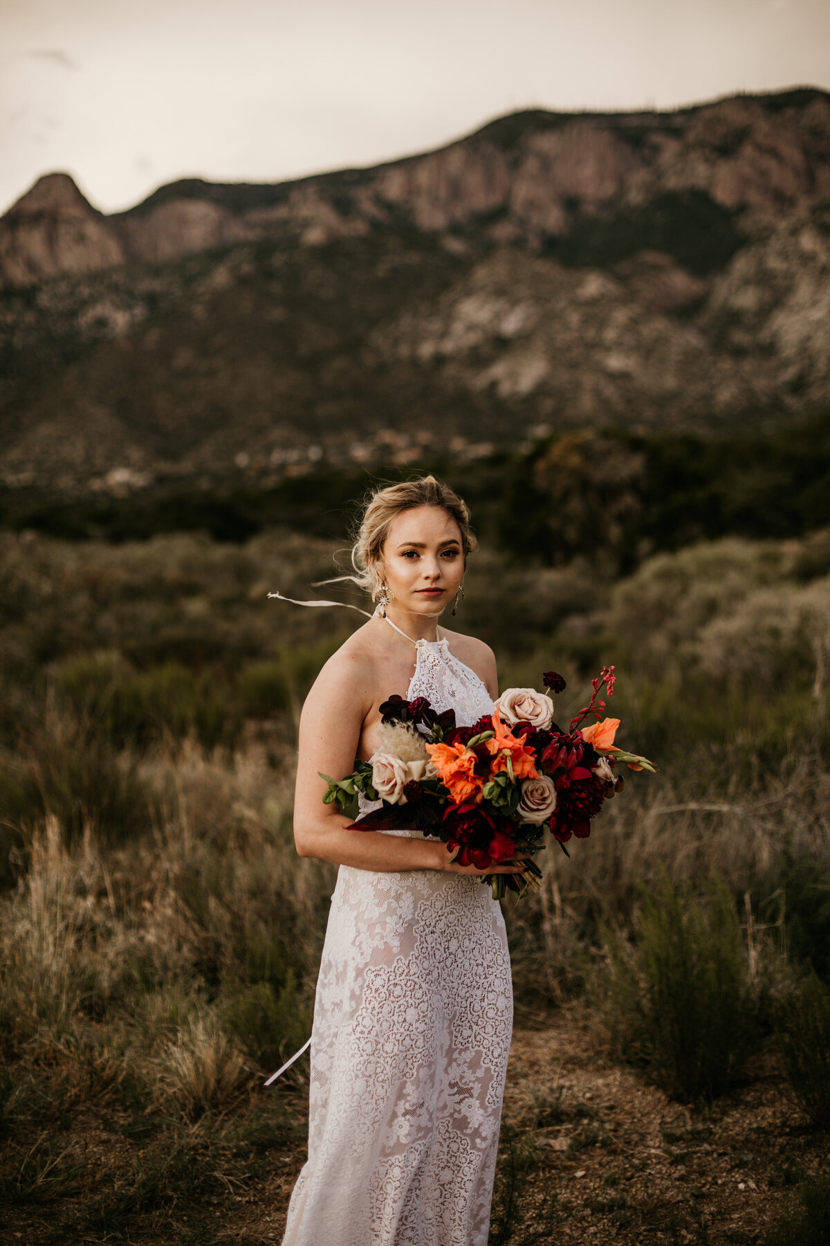 bride holding bouquet in desert