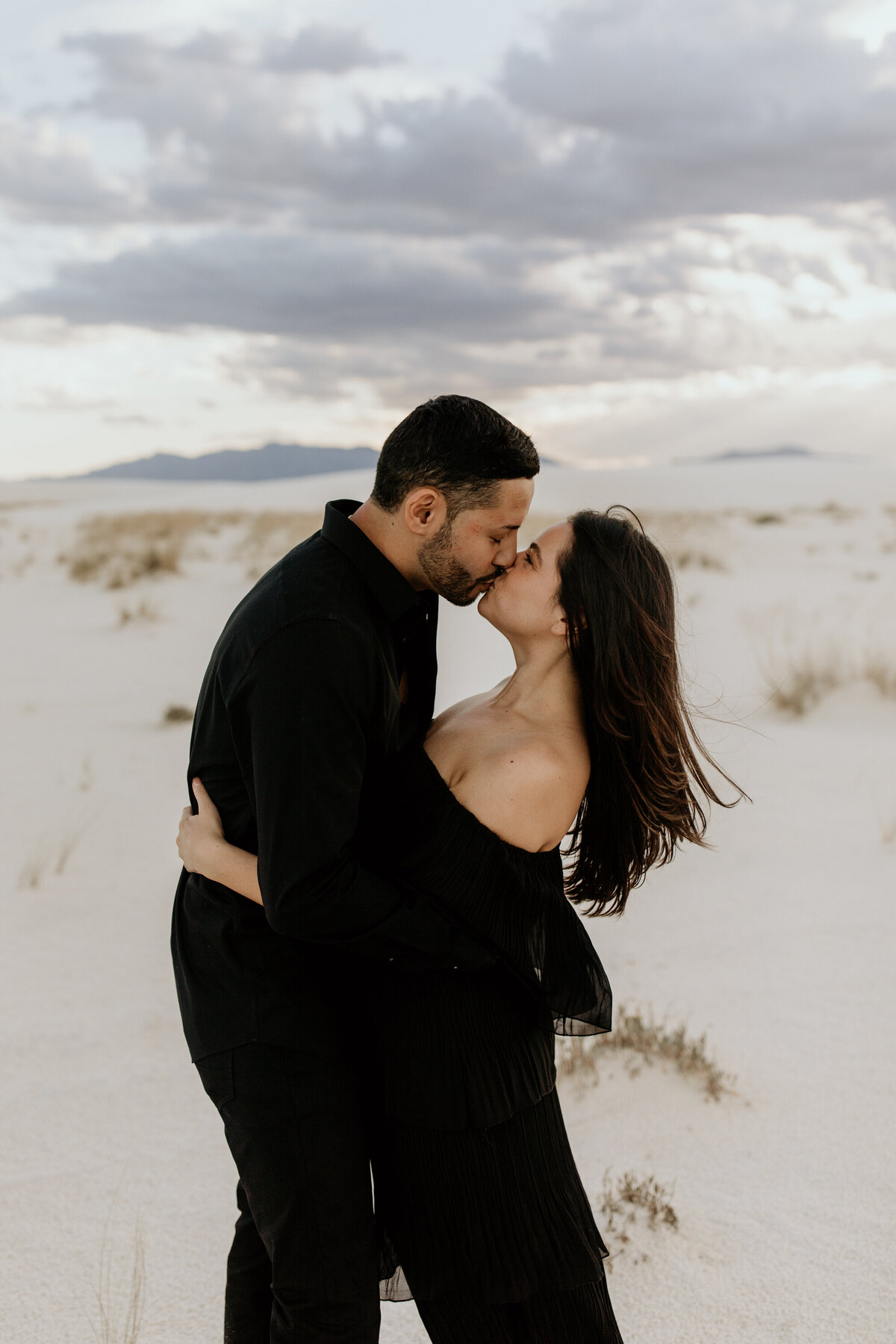engaged couple kissing at white sands national park