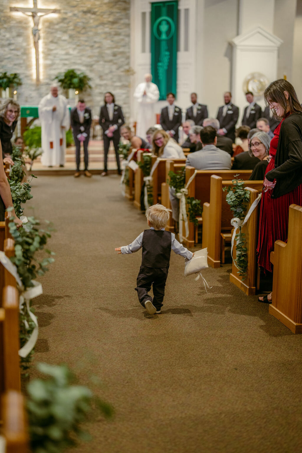 Ring bearer running down the aisle 