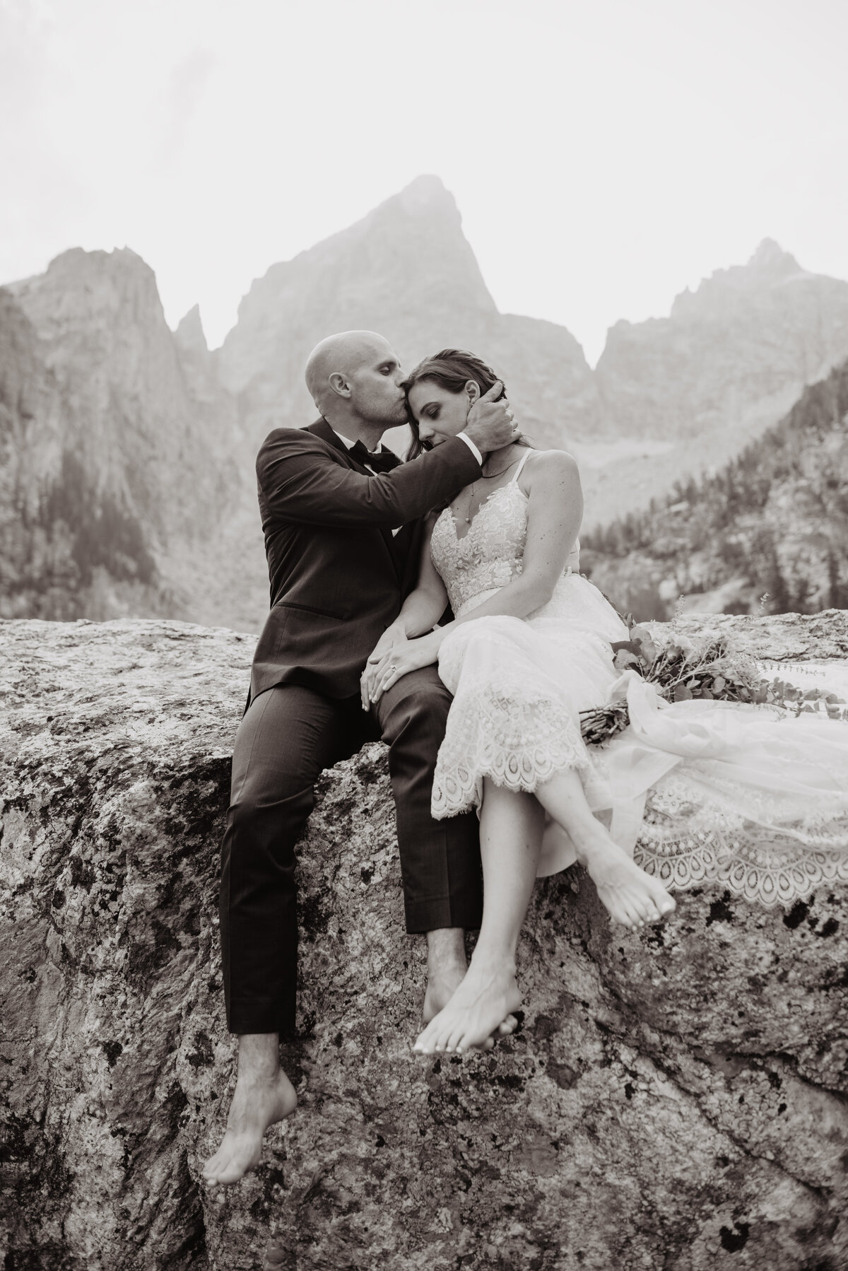 Jackson Hole Photographers capture groom kissing bride's forehead