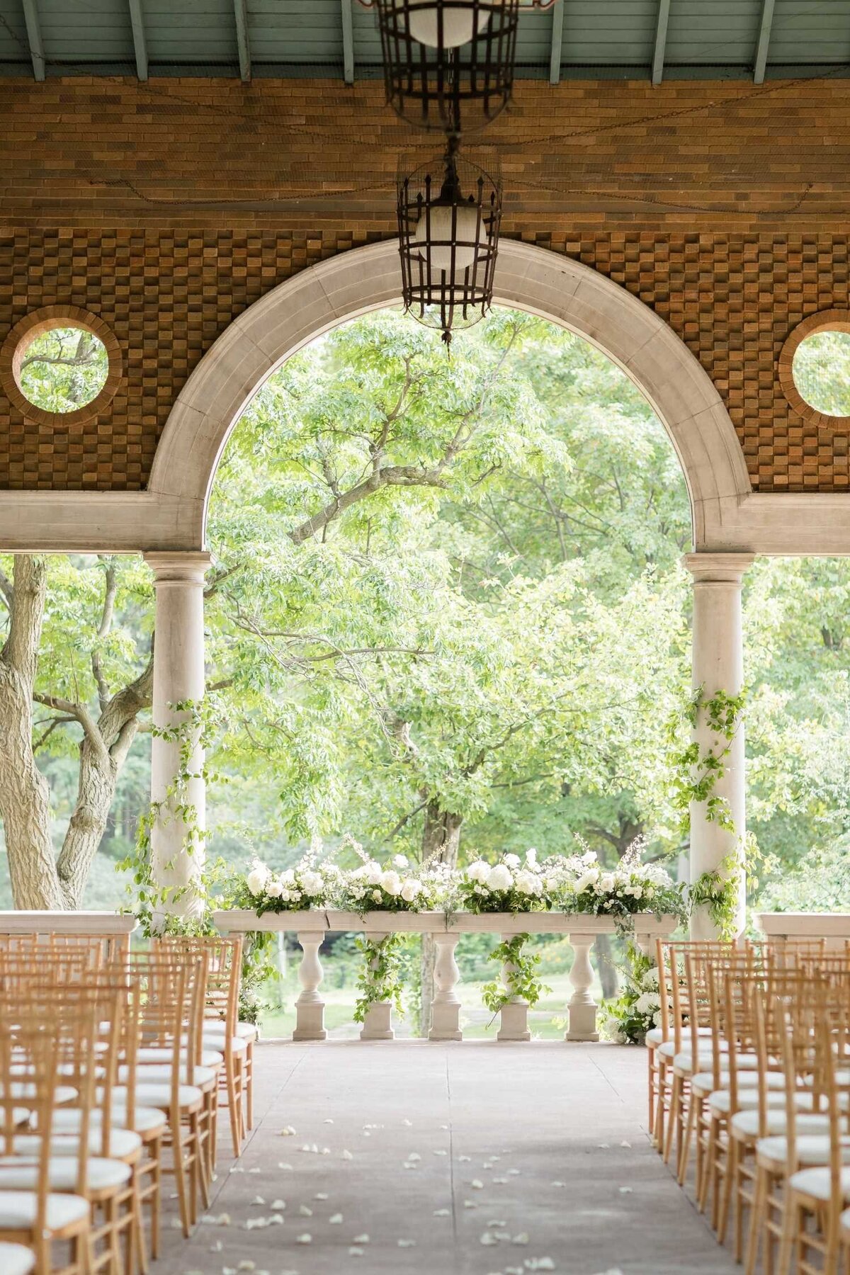Wedding Ceremony with lush white and green floral at Columbus Park Refectory for a Luxury Chicago Outdoor Historic Wedding Venue.