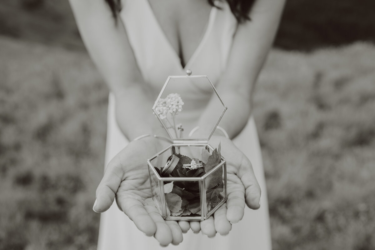 Bride holds a glass ring box out for a closer look at her Ouray, Colorado Elopement wedding details