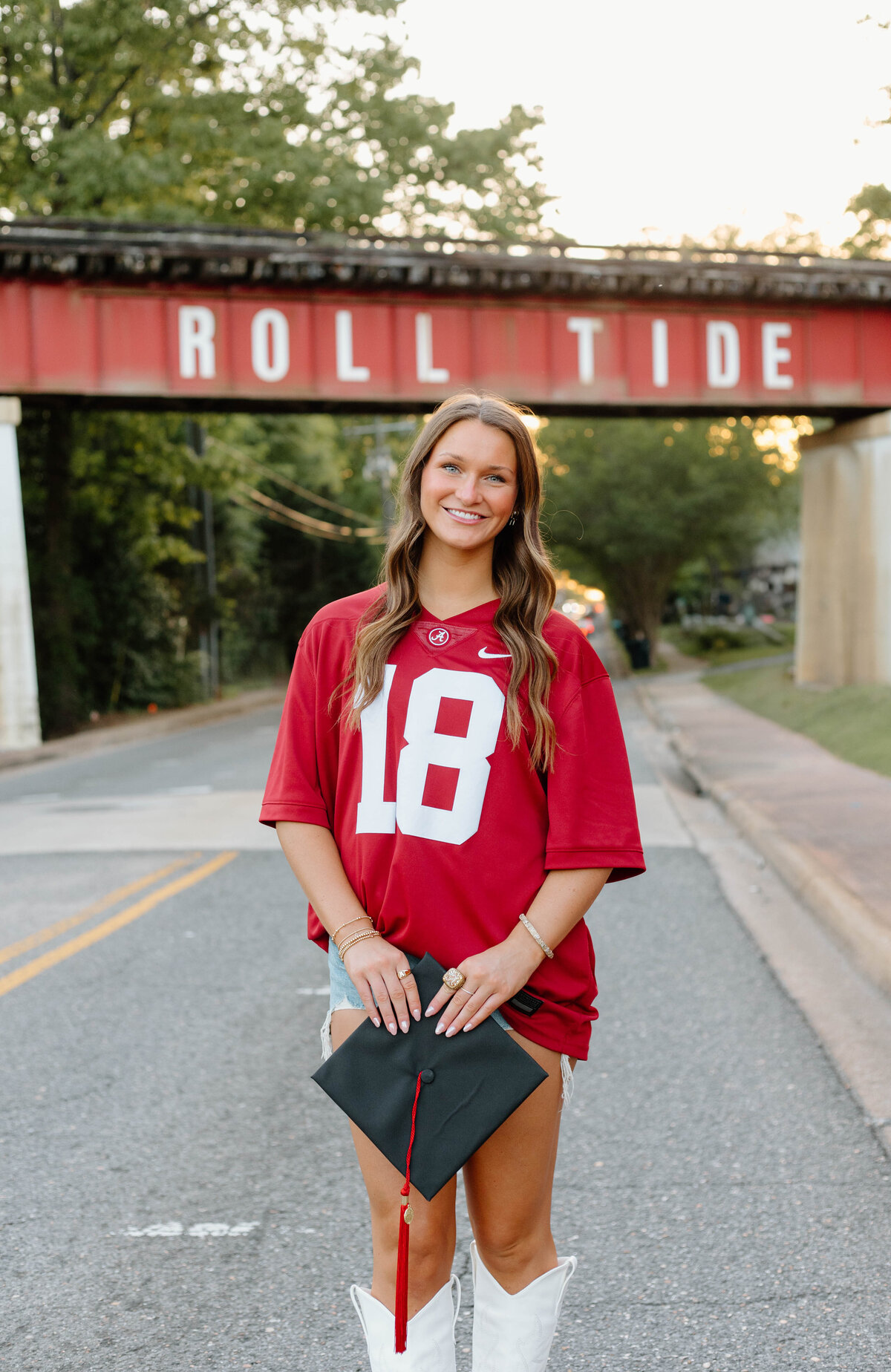 UA grad in Alabama Jersey at the roll tide bridge