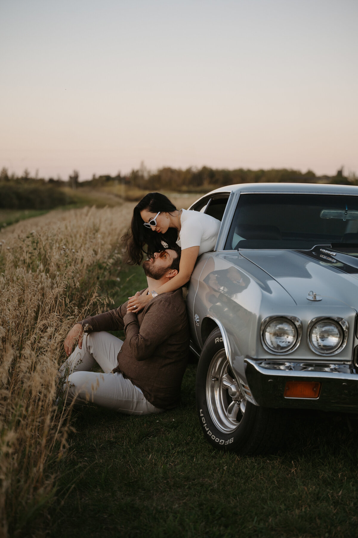 Couple poses for photograph with their sports car in Edmonton Alberta