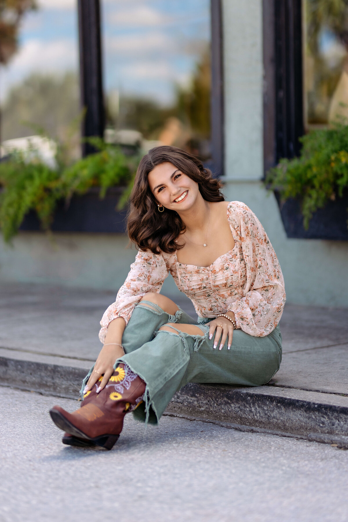 High school senior in front of matte gray city-inspired backdrop in Orlando