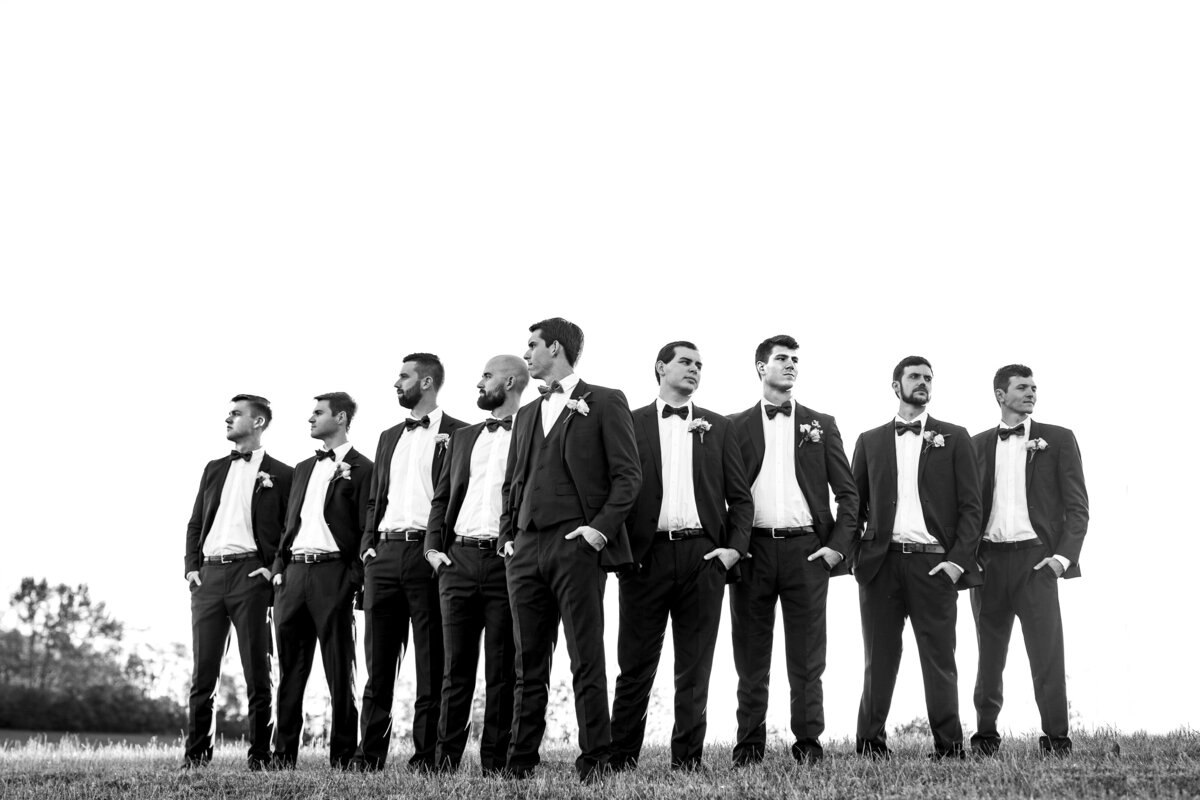 black and white image of men in black tux