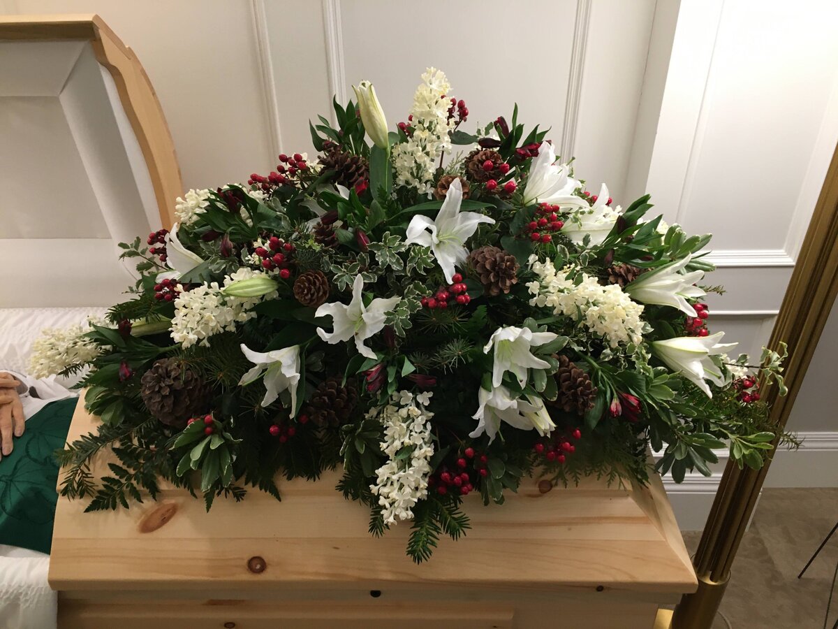 white lilies red roses white lilacs and pine cones funeral casket flowers at White Pine Funeral Flowers
inside-the-casket-arrangement
