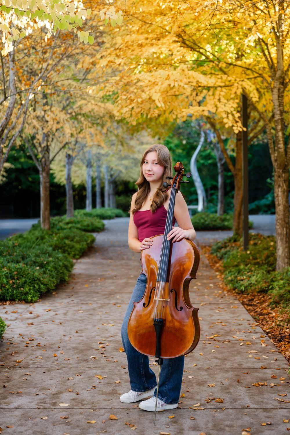 high school senior with cello at bellevue botanical garden in fall