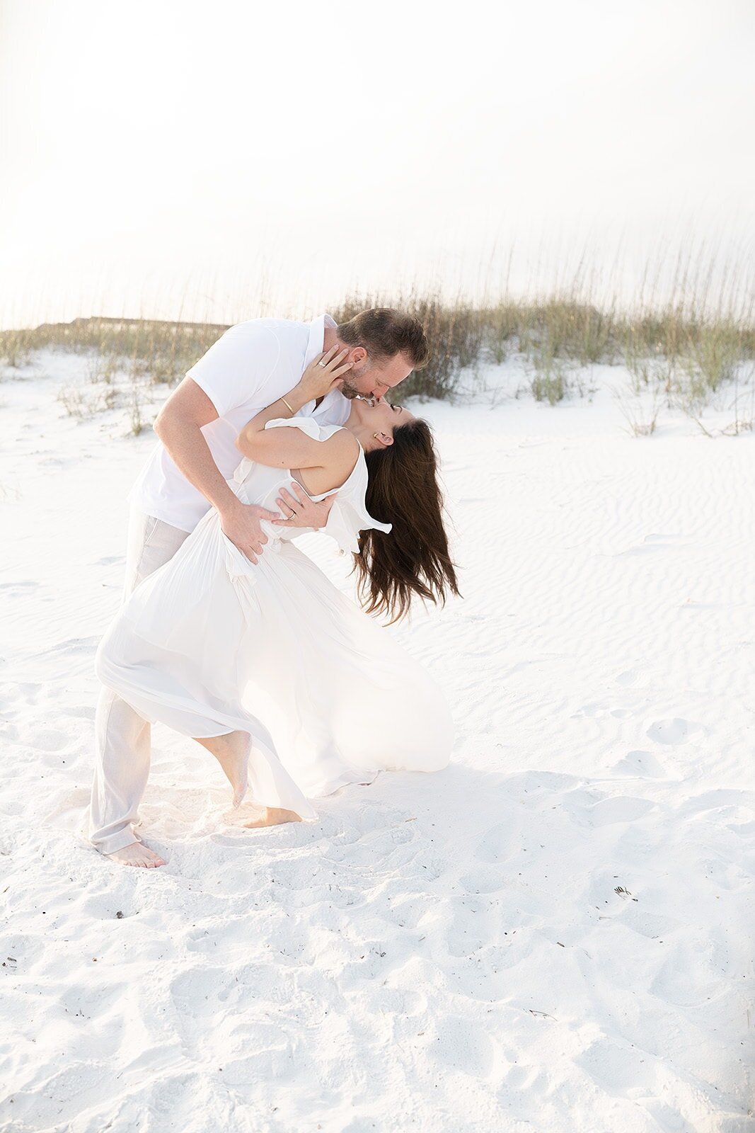 a couple kissing at Henderson beach state park in Destin Florida
