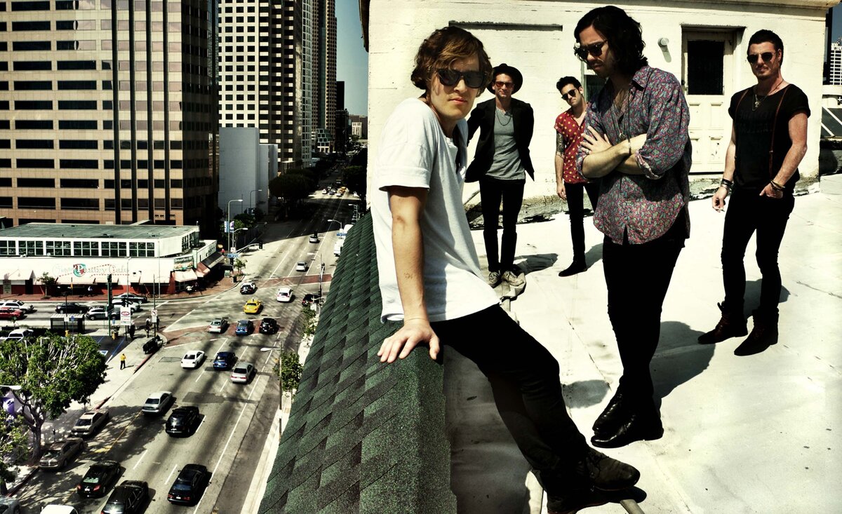 Rock band portrait Terraplane Sun standing on rooftop with street traffic below