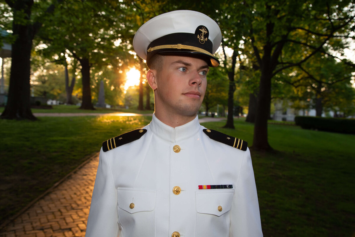 Naval Academy senior picture in whites on Stibling Walk with golden light.