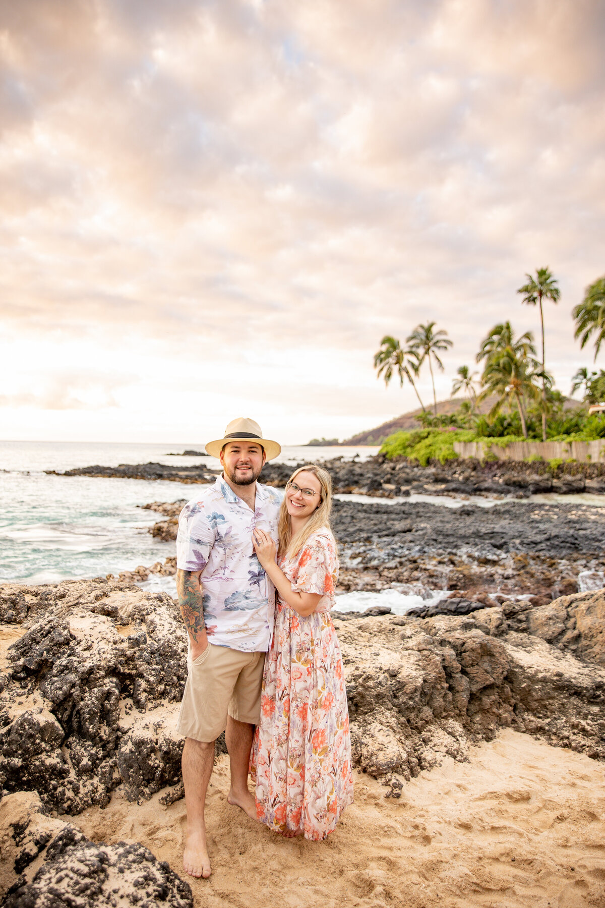 Maui Family Photographers capture couple standing together wearing tropical clothing at beach family photos