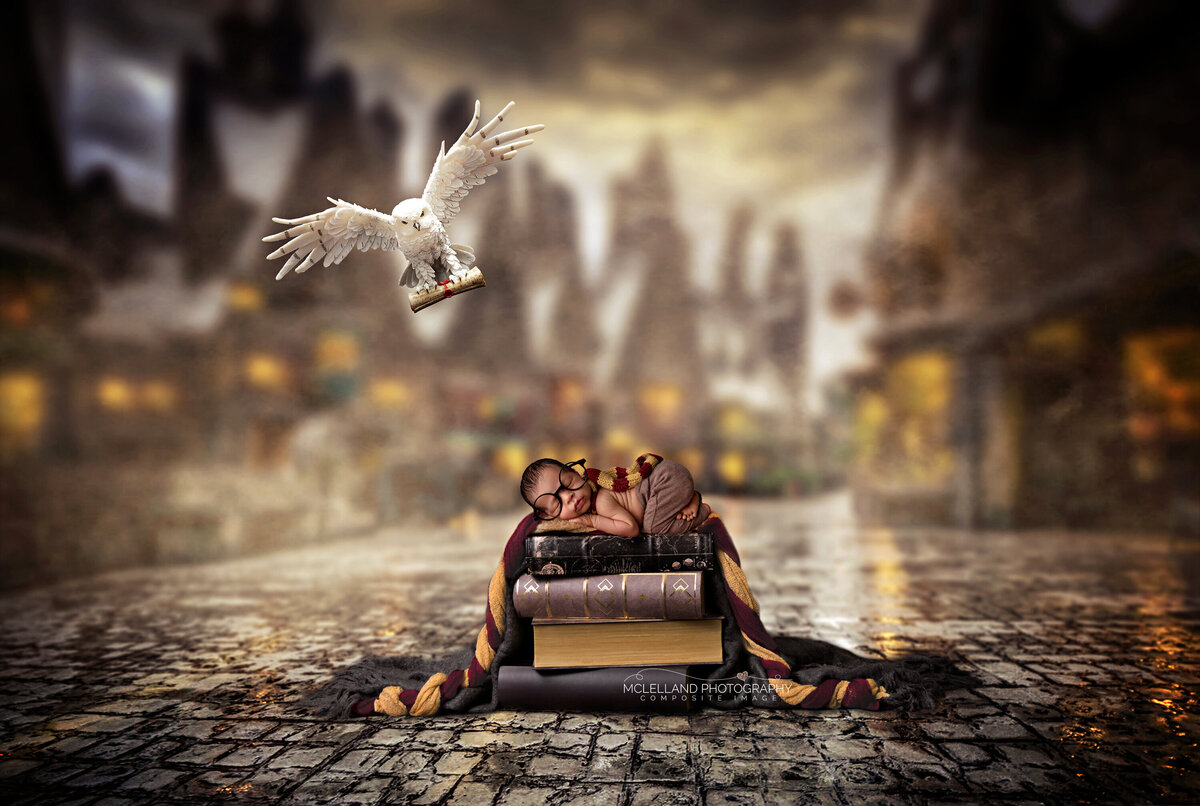 Newborn baby in a wizard-themed scene on a tiny bed with a magical cityscape background.