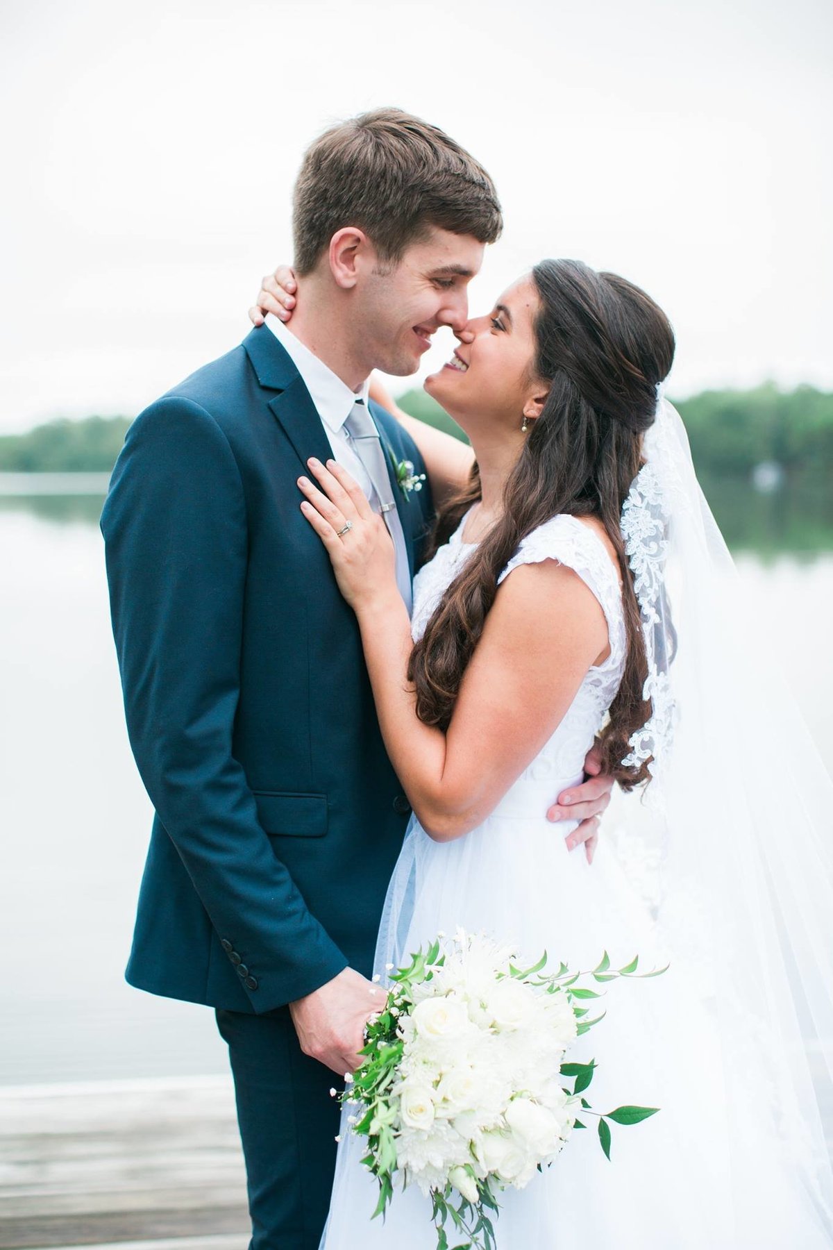 Wedding Photographer, bride with her arm around groom's neck